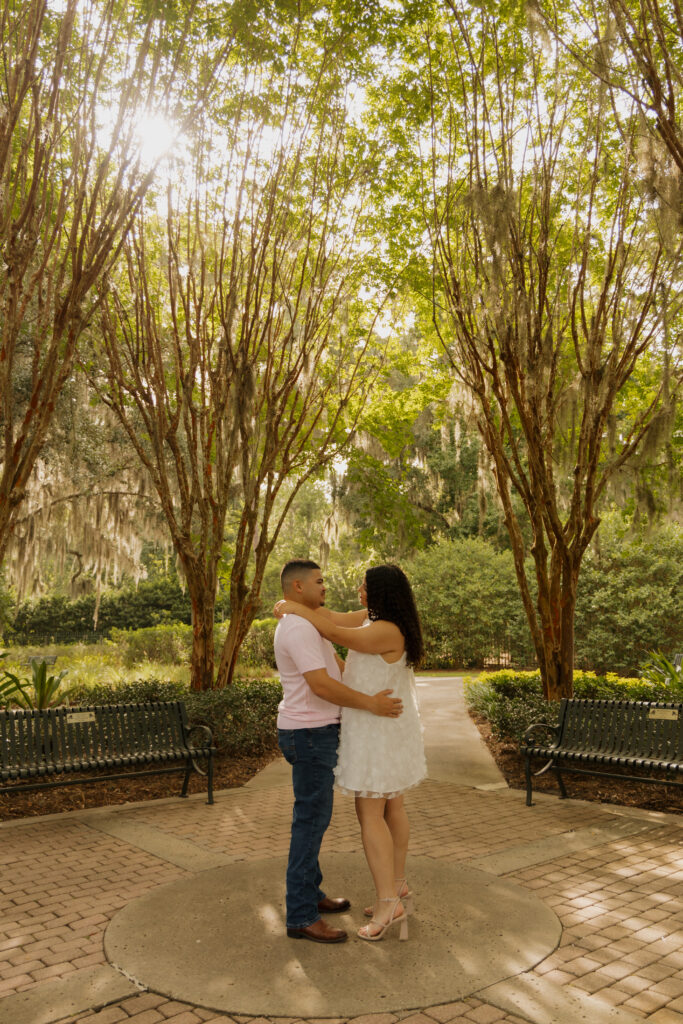 Engagement portraits surrounded by flowers at Sholom Park