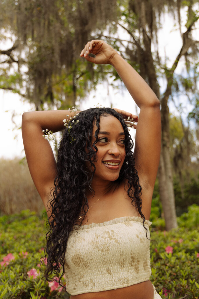 Woman smiling with flowers tucked into her hair during a Sholom Park branding session