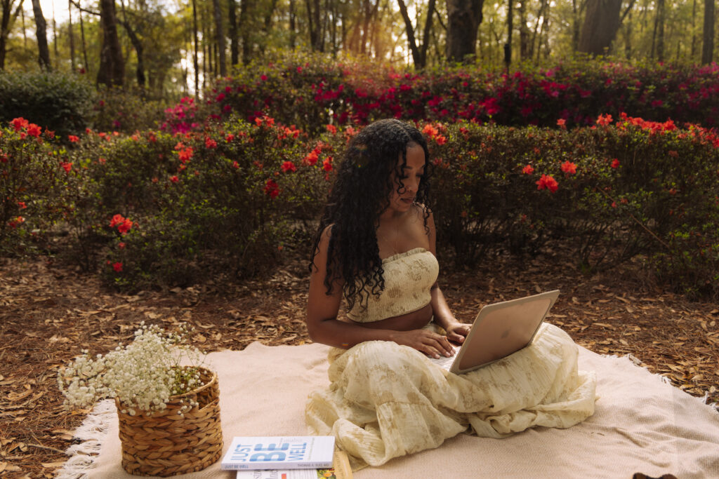 Woman working on a laptop during a relaxed outdoor branding session at Sholom Park