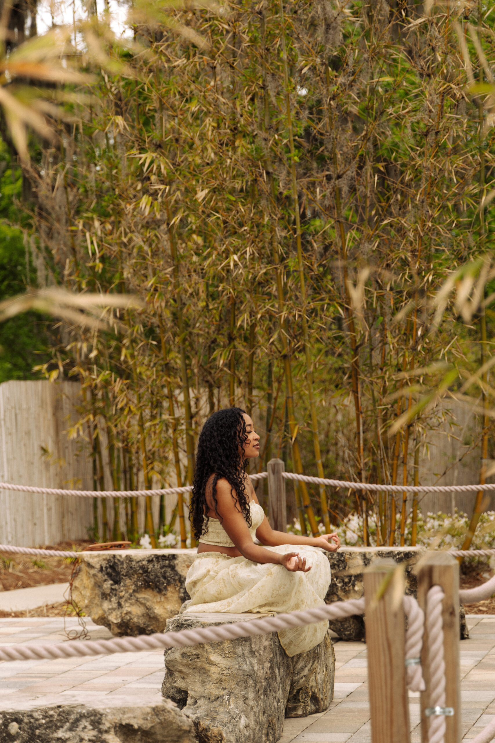 Holistic wellness professional sitting on a garden bench with a wellness book at Sholom Park