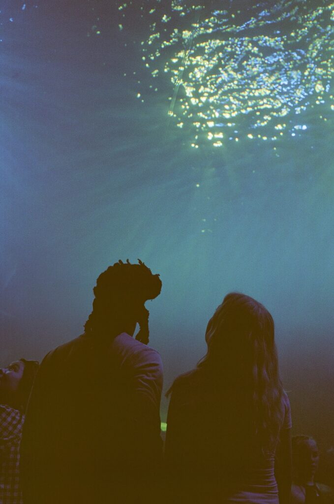 A film photo captures the couple exploring Mote Aquarium together.