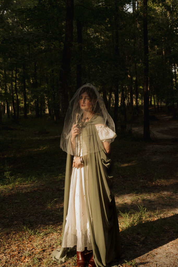 Woman holding a sword while wearing a veil during a medieval inspired portrait session at Scott Springs Park