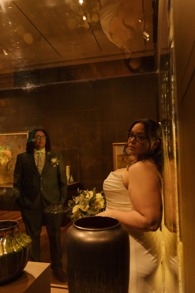Bride and groom posing inside the Morse Museum during their Winter Park Florida elopement