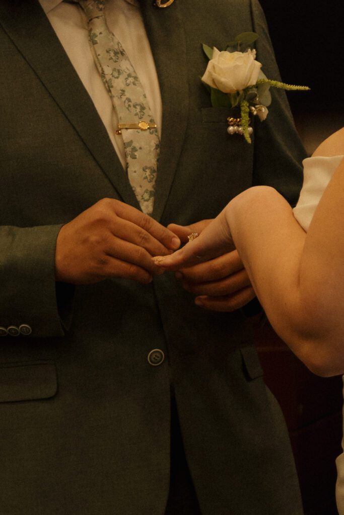 Groom placing a wedding ring on the bride’s finger during their Orlando courthouse elopement