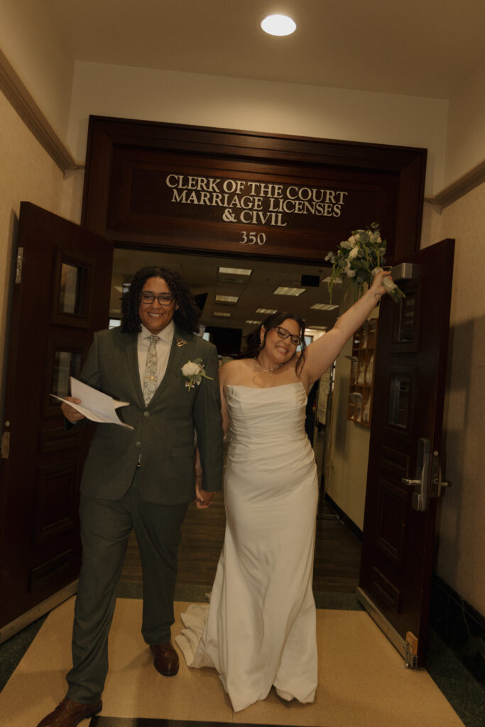 Newlyweds celebrating outside the marriage license office at the Orange County Courthouse in Orlando