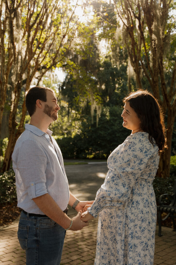 Romantic engagement portrait surrounded by greenery at Sholom Park