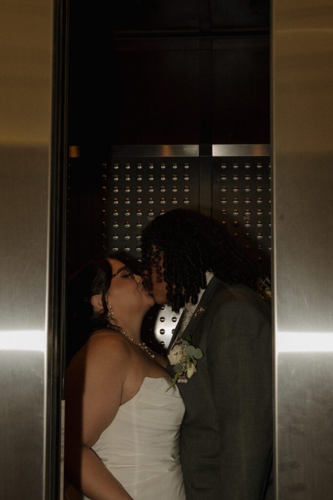 Bride and groom kissing in the elevator after their Orlando courthouse elopement